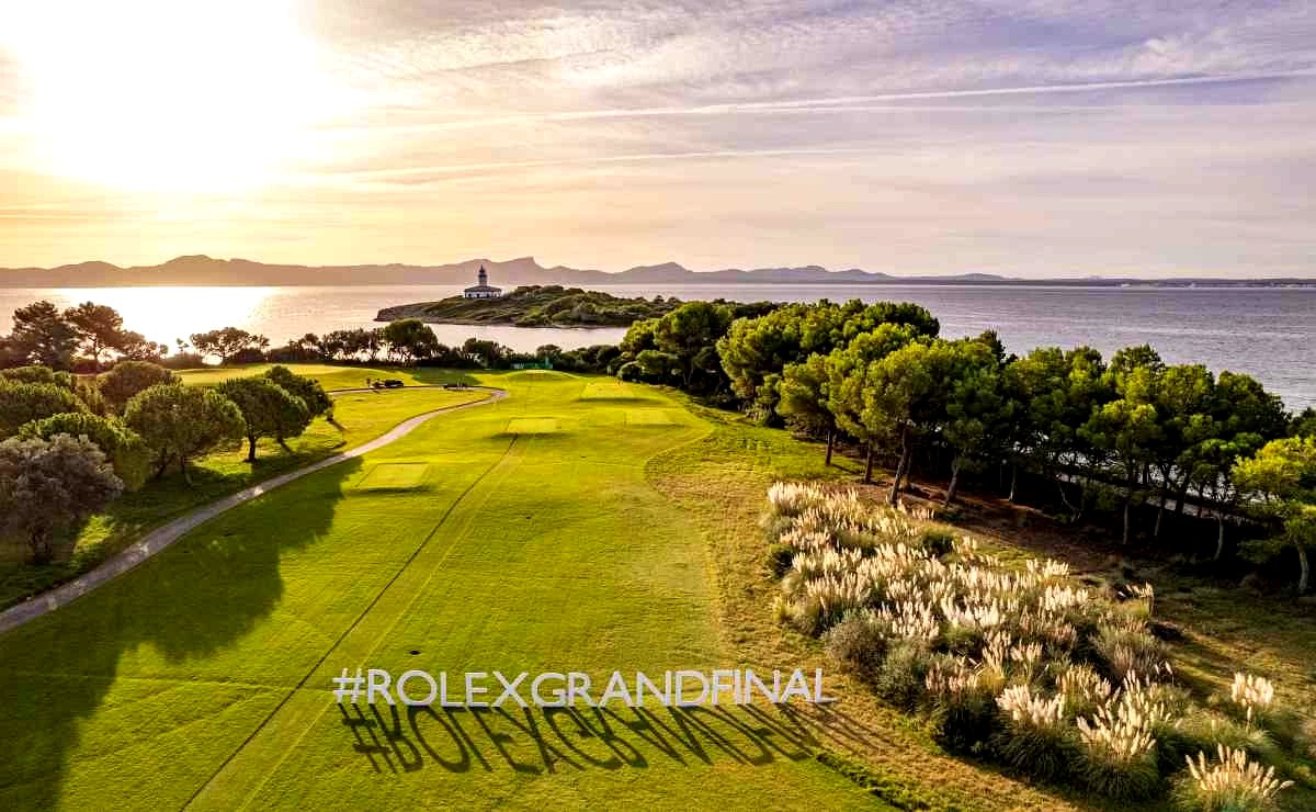 Club de Golf Alcanada at golden hour — lighthouse and bay